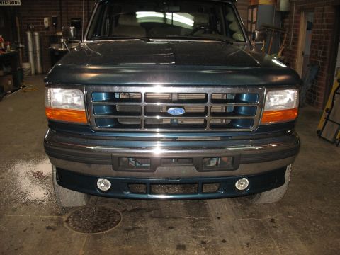 1995 Ford C-350 (Centurion Conversions) - Front view of a 1995 Ford C-350 (Centurion Conversions) truck in a garage.