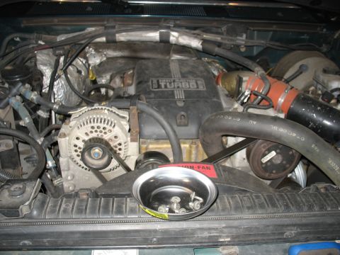 1995 Ford C-350 (Centurion Conversions) - The engine bay of a 1995 Ford C-350 (Centurion Conversions) is pictured, with a parts tray on the radiator.