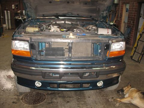 1995 Ford C-350 (Centurion Conversions) - Front view of a teal 1995 Ford C-350 (Centurion Conversions) with the hood open, revealing the engine and intercooler.