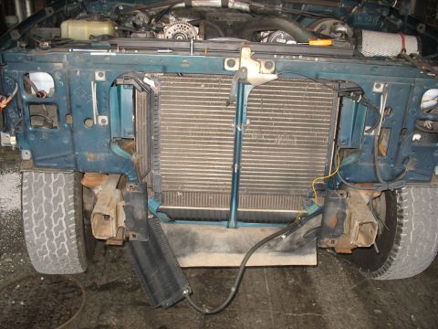 1995 Ford C-350 (Centurion Conversions) - Front end of a truck with radiator and intercooler removed, exposing engine bay and tires.