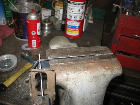 1995 Ford C-350 (Centurion Conversions) - Workbench setup with tools including a vise, hammer, spray can, and a fire extinguisher.