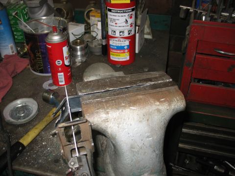1995 Ford C-350 (Centurion Conversions) - A workbench scene a vise, tools, and a fire extinguisher, suggesting a workshop environment.