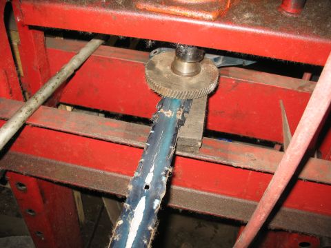 1995 Ford C-350 (Centurion Conversions) - A metal component is being worked on by a gear mechanism within industrial machinery.