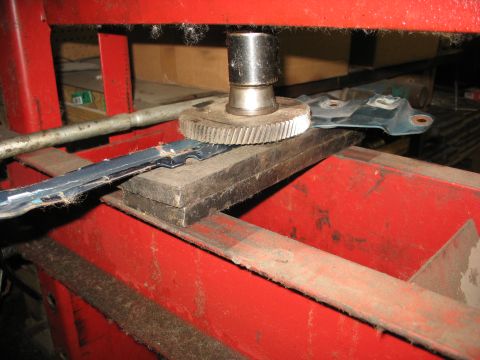 1995 Ford C-350 (Centurion Conversions) - A gear is used to press a metal bracket on a hydraulic press.