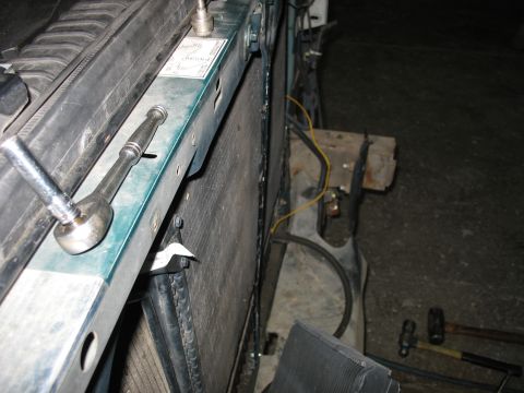 1995 Ford C-350 (Centurion Conversions) - Close-up view of an engine bay, showing a radiator, intercooler, and tools, suggesting maintenance or modification work.