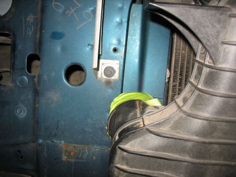 1995 Ford C-350 (Centurion Conversions) - Detail of intercooler piping and radiator in a vehicle's engine bay, with some handwritten markings on the blue metal panel.
