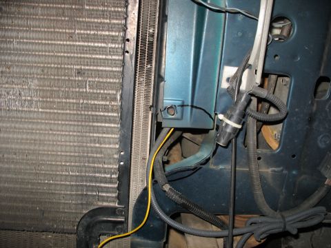 1995 Ford C-350 (Centurion Conversions) - Close-up view of the intercooler and radiator assembly, showing wiring and a blue body panel.