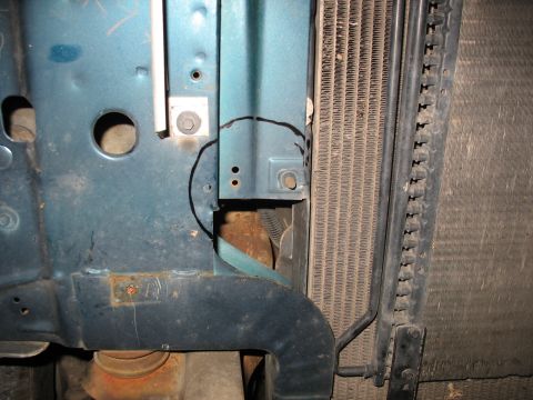 1995 Ford C-350 (Centurion Conversions) - Close-up of a blue metal bracket near a radiator, possibly for intercooler mounting.