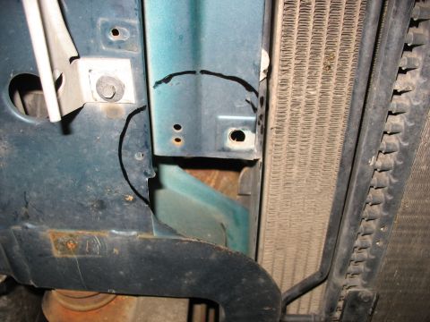 1995 Ford C-350 (Centurion Conversions) - Detail shot of the front end of a vehicle, focusing on the radiator and surrounding metalwork.