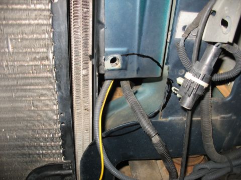 1995 Ford C-350 (Centurion Conversions) - Detail of engine bay components, including a radiator and blue painted metal structure with visible wiring and hoses.
