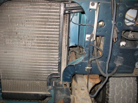 1995 Ford C-350 (Centurion Conversions) - Close-up view of a vehicle's radiator and engine bay, showing various parts and wiring.
