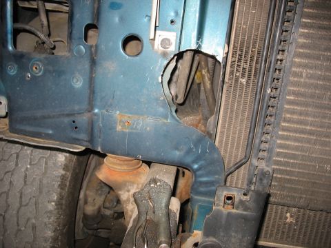 1995 Ford C-350 (Centurion Conversions) - The front section of a vehicle, including the frame and radiator, shows signs of wear and modification.