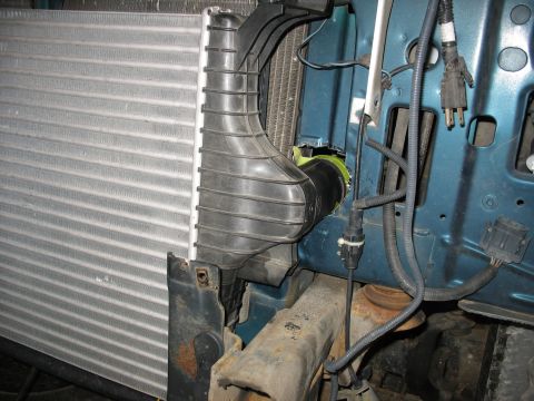1995 Ford C-350 (Centurion Conversions) - Close-up view of intercooler and intake plumbing within a vehicle's engine bay.