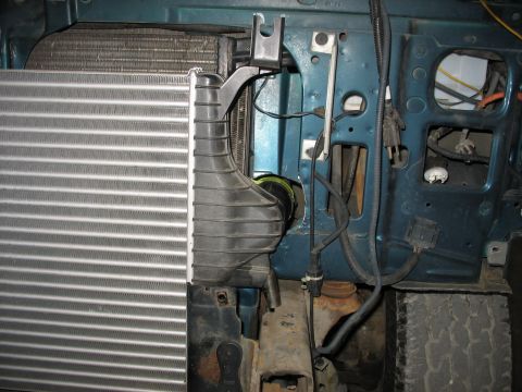 1995 Ford C-350 (Centurion Conversions) - The intercooler and radiator assembly in a vehicle's engine bay, with visible hoses and electrical connections.