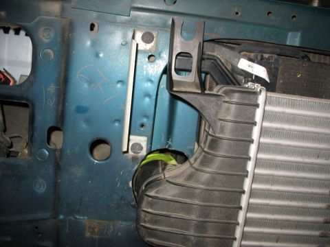 1995 Ford C-350 (Centurion Conversions) - Close-up of engine bay components, including a radiator and intake ducting, in a teal vehicle.