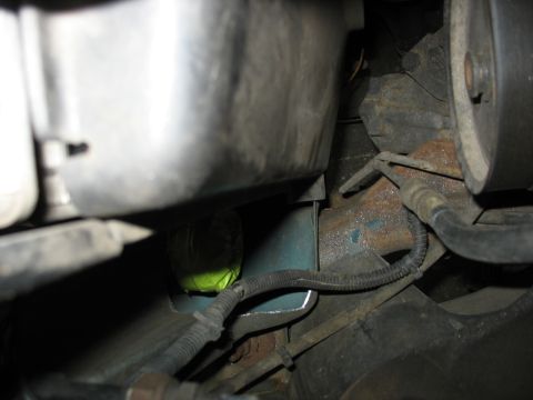1995 Ford C-350 (Centurion Conversions) - A close-up view of engine bay components, including hoses and metal brackets.