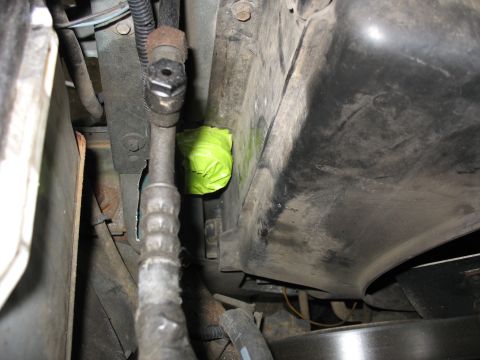 1995 Ford C-350 (Centurion Conversions) - Close-up view of engine bay components, including a pipe covered in green tape and various hoses.