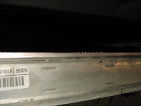 1995 Ford C-350 (Centurion Conversions) - A close-up view of an intercooler, showing the part number N1WLB 5B02A.