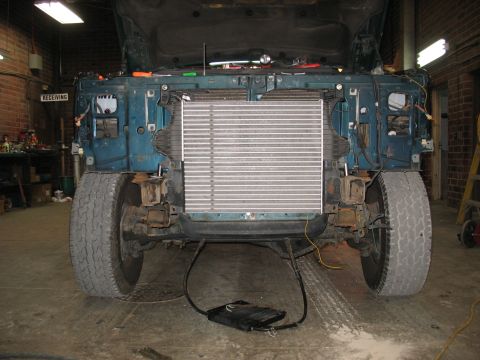 1995 Ford C-350 (Centurion Conversions) - The front of a truck is disassembled, revealing the intercooler and engine components.