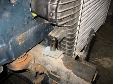 1995 Ford C-350 (Centurion Conversions) - Intercooler piping installation detail, showing connection to the radiator and a socket wrench.