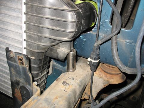 1995 Ford C-350 (Centurion Conversions) - A close-up view of engine bay components, including part of the radiator and air intake system.