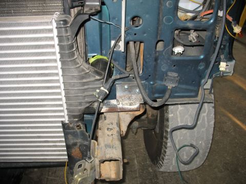 1995 Ford C-350 (Centurion Conversions) - Close-up view of a vehicle's front end, showing the intercooler and associated wiring.