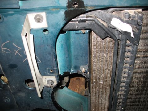 1995 Ford C-350 (Centurion Conversions) - Detail shot of the radiator and surrounding components within a vehicle's engine bay.