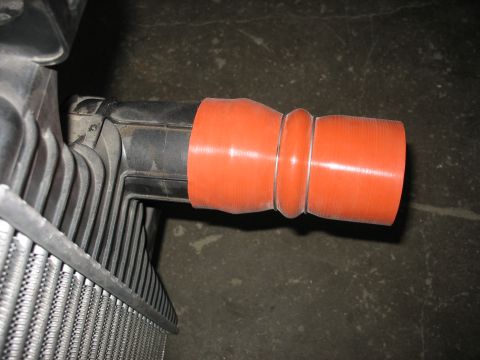 1995 Ford C-350 (Centurion Conversions) - Close-up of a vehicle's intercooler piping system, showing a silicone hose attached to a plastic component.