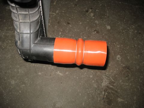 1995 Ford C-350 (Centurion Conversions) - Close-up of an intercooler pipe connection with an orange coupler.