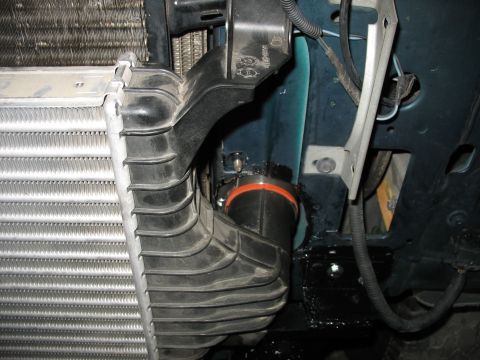 1995 Ford C-350 (Centurion Conversions) - Close-up view of intercooler and intake piping installation, showing a black hose with an orange seal.