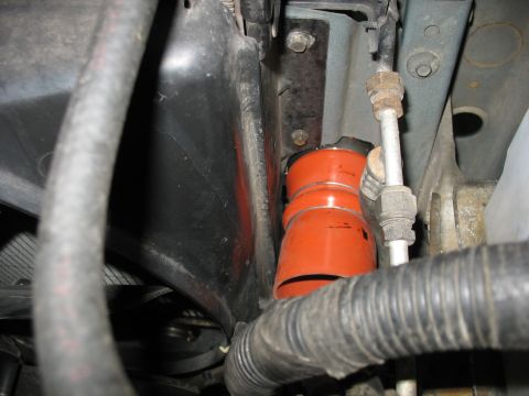 1995 Ford C-350 (Centurion Conversions) - Close-up of an orange silicone coupler hose, likely part of an intercooler system.