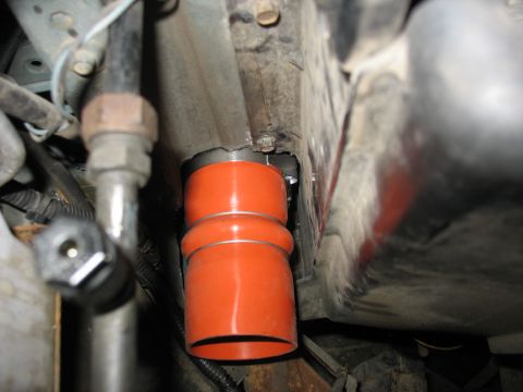 1995 Ford C-350 (Centurion Conversions) - A close-up view of an orange intercooler hose, likely part of a vehicle's turbo system.
