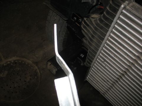 1995 Ford C-350 (Centurion Conversions) - Close-up view of an intercooler assembly being installed or serviced on a vehicle.