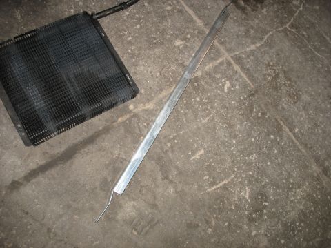 1995 Ford C-350 (Centurion Conversions) - Intercooler and metal bracket on concrete floor.