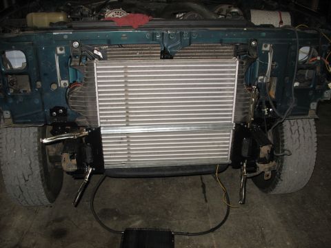 1995 Ford C-350 (Centurion Conversions) - The front of a vehicle is shown with the radiator removed and a large intercooler installed in its place.