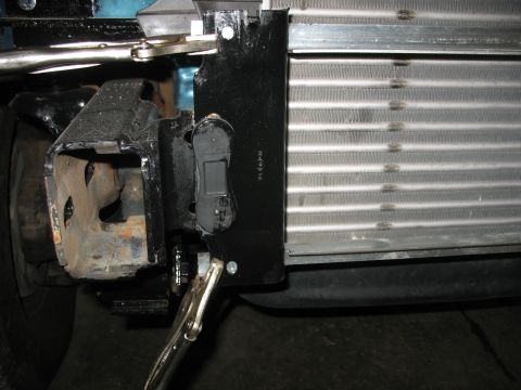 1995 Ford C-350 (Centurion Conversions) - Close-up view of an intercooler being installed, with vise grips securing a bracket.