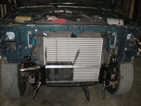 1995 Ford C-350 (Centurion Conversions) - Front end of a 1995 Ford C-350 (Centurion Conversions) with the hood open, displaying an intercooler installation.
