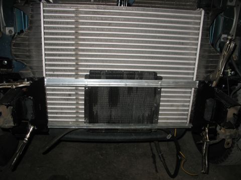 1995 Ford C-350 (Centurion Conversions) - Close-up of a vehicle's front end showing a large radiator and a smaller intercooler mounted in front of it.