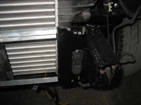 1995 Ford C-350 (Centurion Conversions) - Close-up view of the front end components, focusing on the radiator and intercooler, with visible wiring and mounting hardware.
