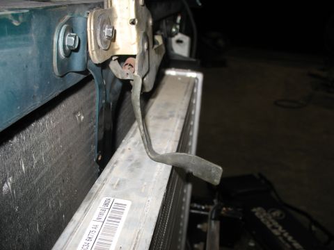 1995 Ford C-350 (Centurion Conversions) - A close-up view of a vehicle's radiator and associated hardware, with a label containing text and a barcode.