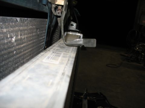 1995 Ford C-350 (Centurion Conversions) - Close-up of vehicle radiator and intercooler components, with a metal bracket attached.