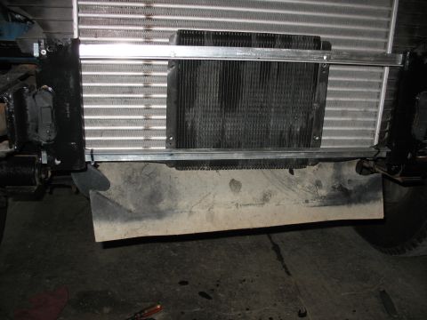 1995 Ford C-350 (Centurion Conversions) - Close-up view of an intercooler being installed on the front of a vehicle.
