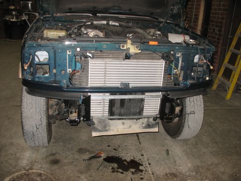 1995 Ford C-350 (Centurion Conversions) - Front view of a green Ford truck with hood open, displaying an intercooler installation and engine components.