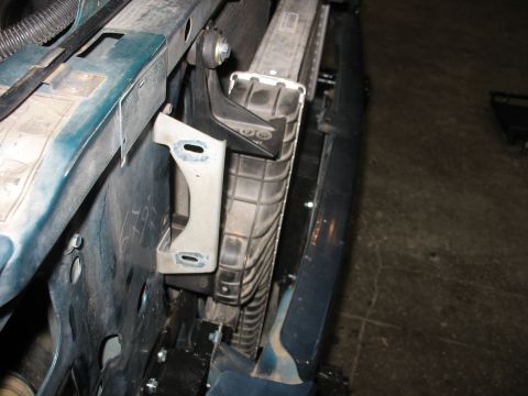 1995 Ford C-350 (Centurion Conversions) - Close-up view of intercooler and radiator mounting brackets, likely during an installation or repair.
