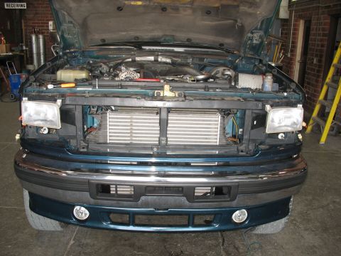 1995 Ford C-350 (Centurion Conversions) - Front view of a teal Ford F-Series truck with the hood open, revealing the intercooler system.
