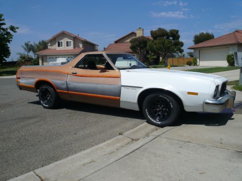 1975 Ford Ranchero - This Ford Ranchero features a unique paint scheme transitioning from white at the front to a gradient of orange and grey towards the rear.