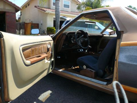 1975 Ford Ranchero - The interior of a 1975 Ford Ranchero shows its brown and tan upholstery and dashboard details.