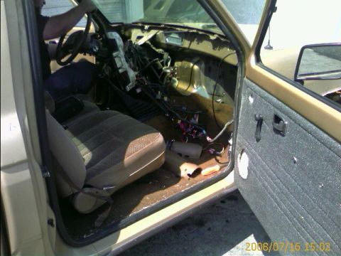 1990 Ford Bronco - View through the open door of a tan truck showing a cloth seat and a gutted dashboard with exposed wiring, date-stamped 2008/07/16.
