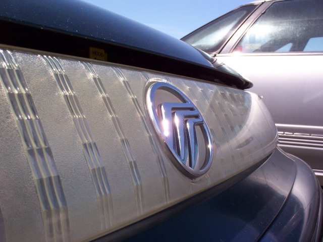 Front lightbar and Mercury logo after I polished the yellow out! It looks so much better.