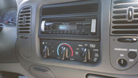 2007 Ford Mustang - Close-up of a vehicle's dashboard, showing the stereo, climate controls, and passenger airbag status.